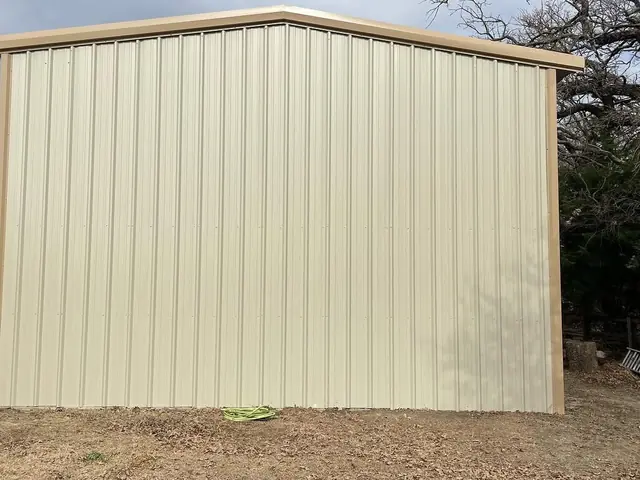The same building from the side, with the wall sheeting and the eave line running the length of it